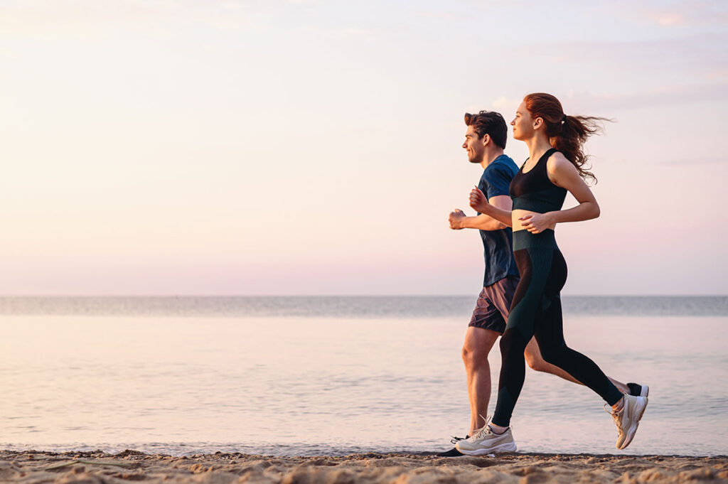 couple jogging along the beach