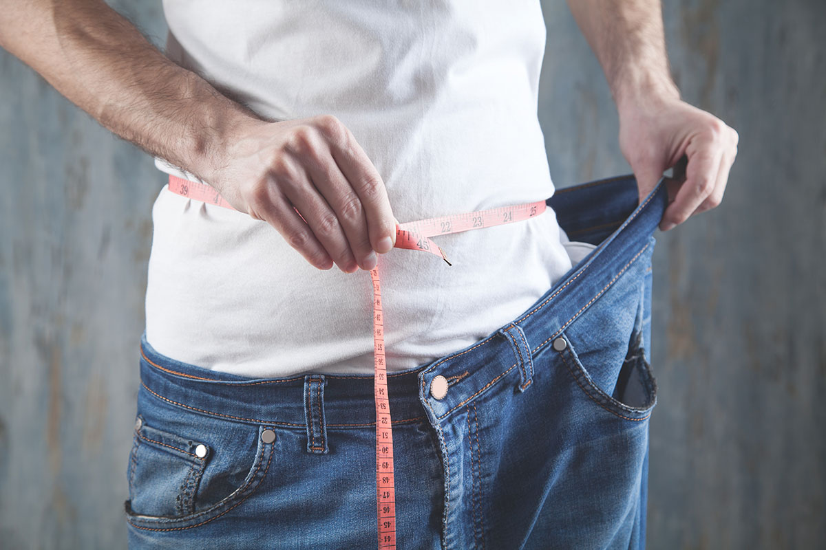 man measuring waist